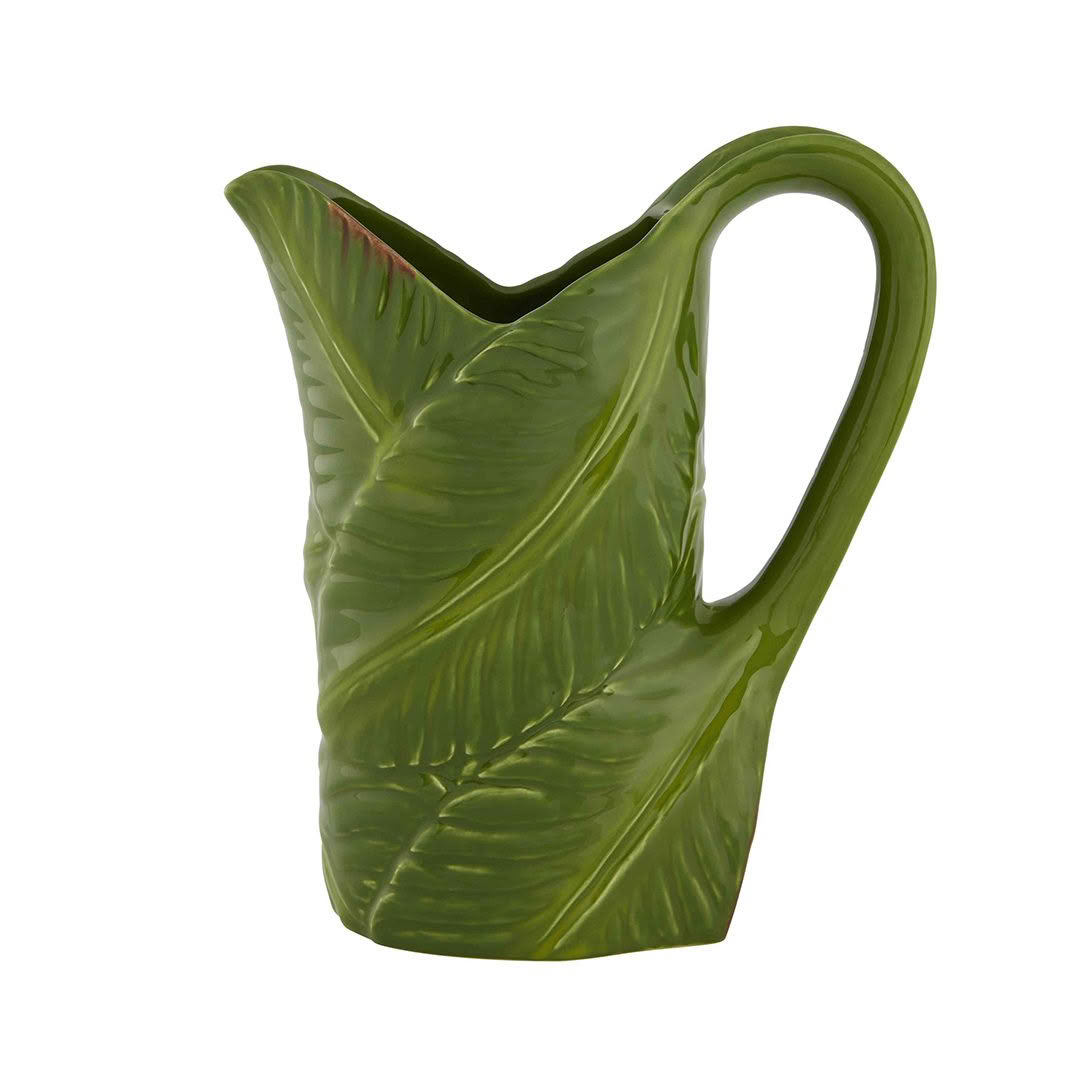 Green leaf-shaped ceramic pitcher isolated on white
