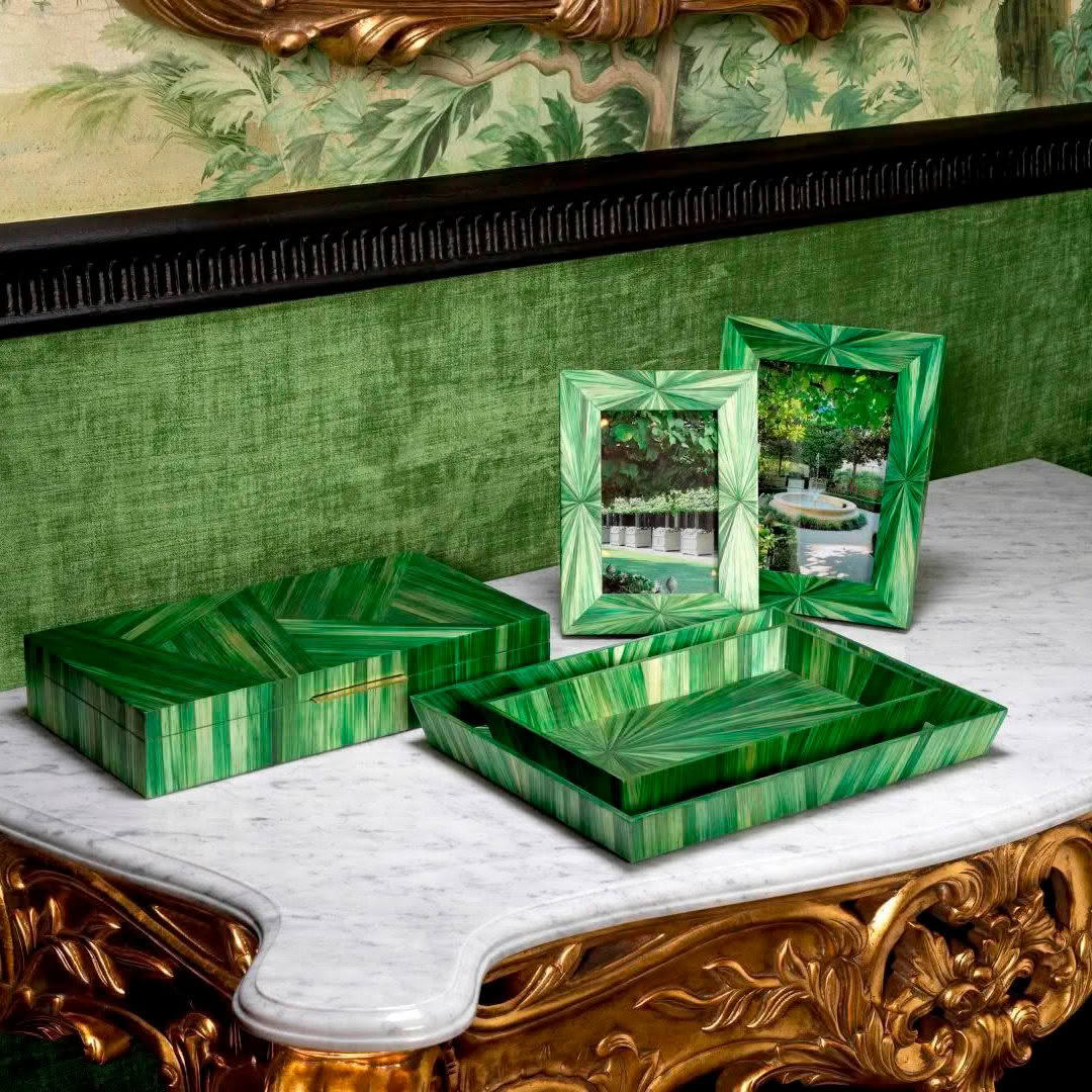 Green malachite frames and boxes on marble table