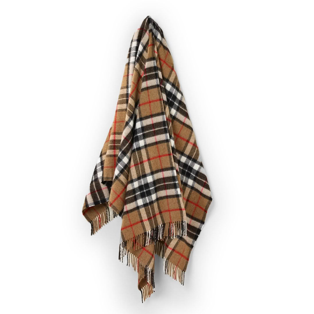 Plaid scarf with fringed edges on white background