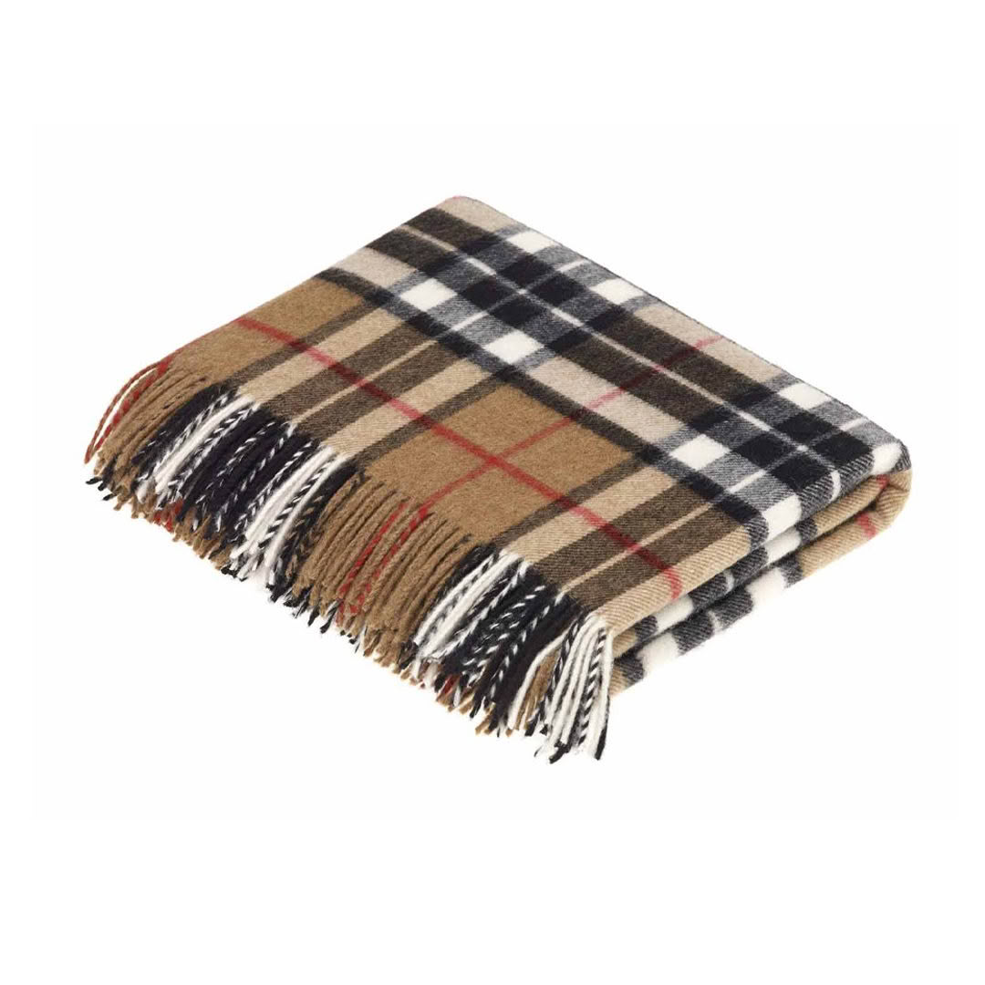 Folded plaid wool blanket with fringe