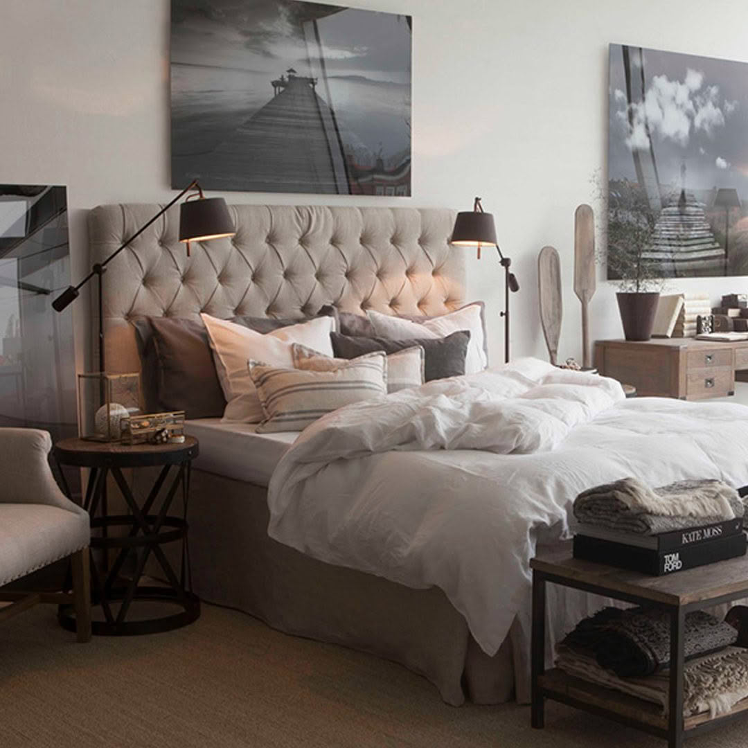 Elegant bedroom with neutral tones and large scenic artwork