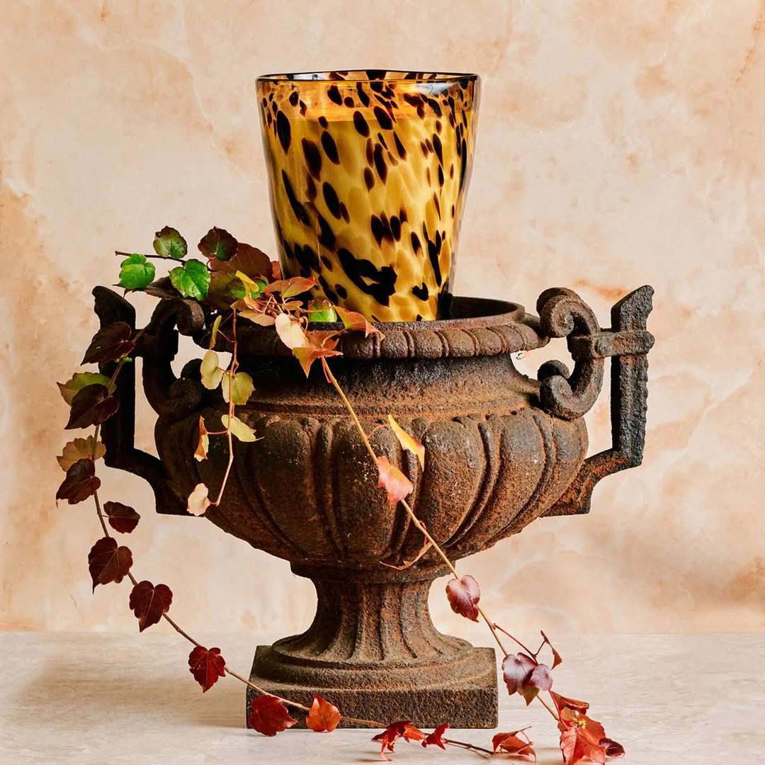 Antique iron urn with tortoiseshell pattern glass on top