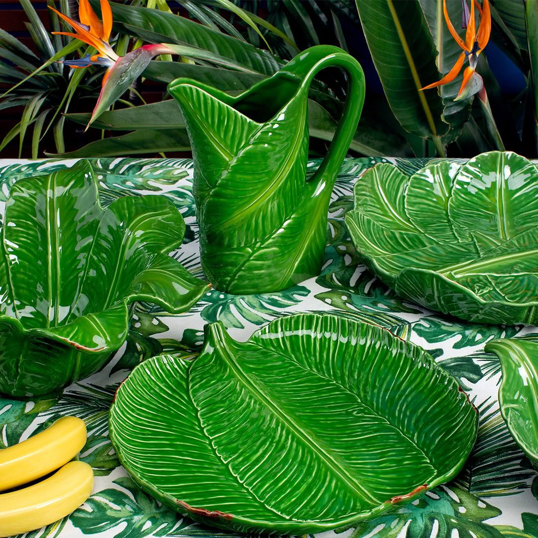 Green leaf-shaped ceramic dishes and pitcher with bananas