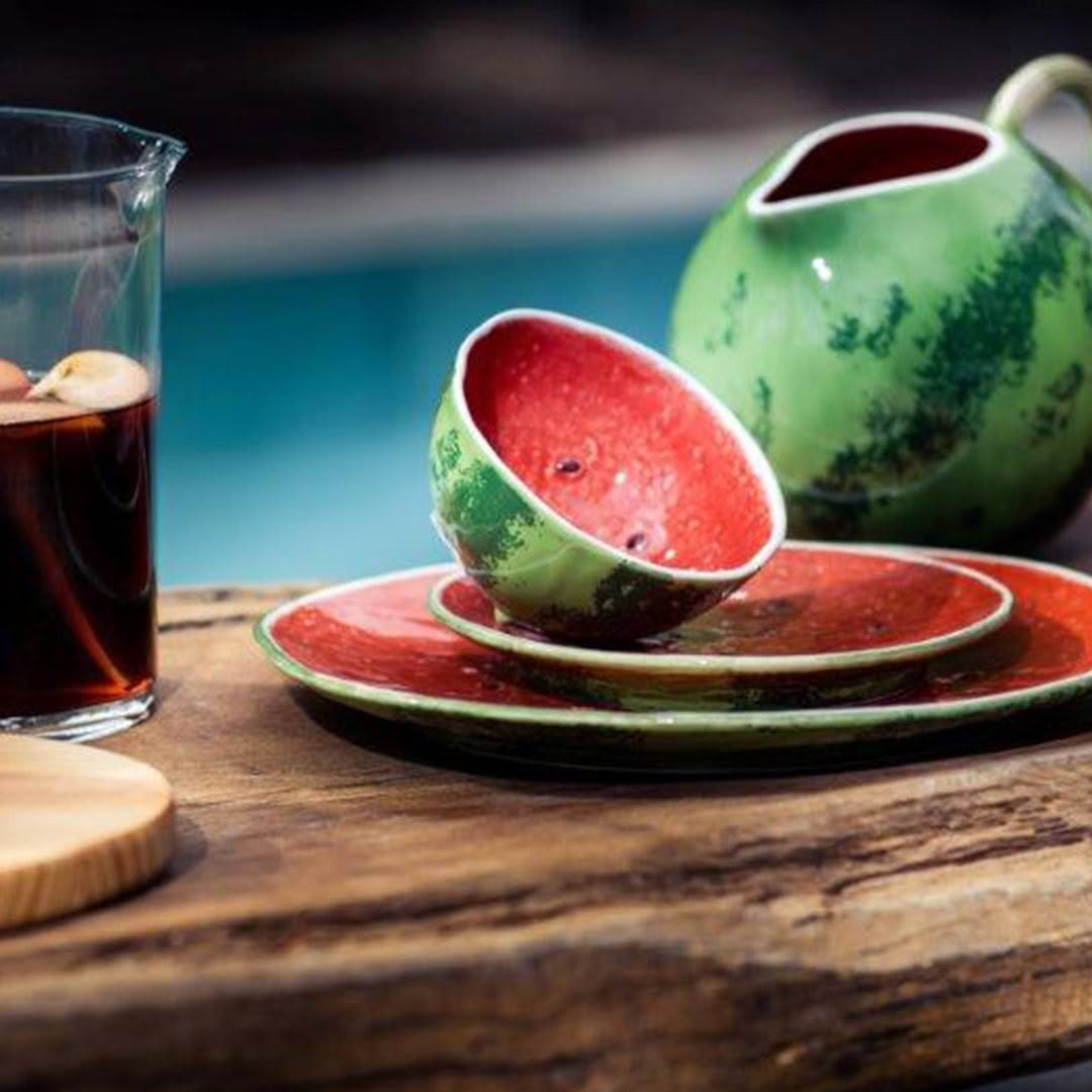 Colorful watermelon-themed ceramic tea set on wooden table