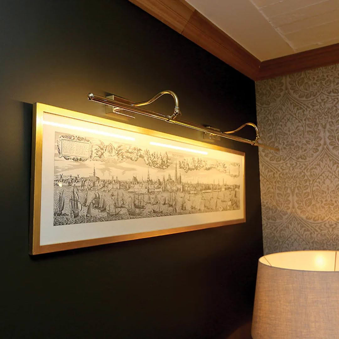 Illuminated framed historical artwork on wall