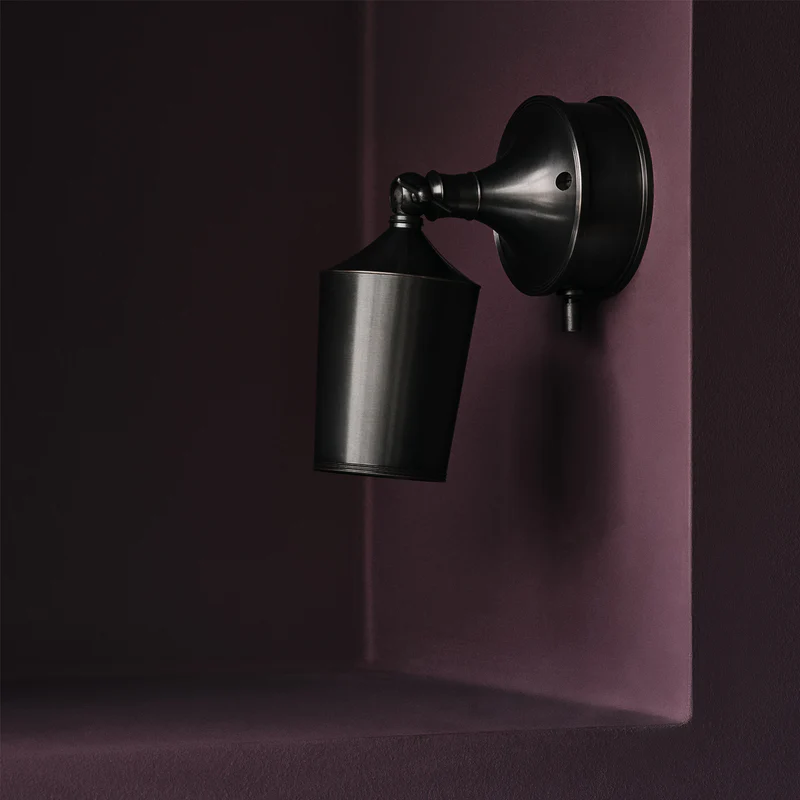 Modern black wall-mounted light on purple background