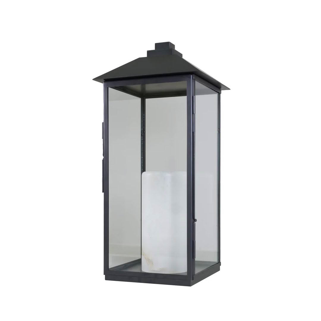 Black outdoor lantern with white candle inside