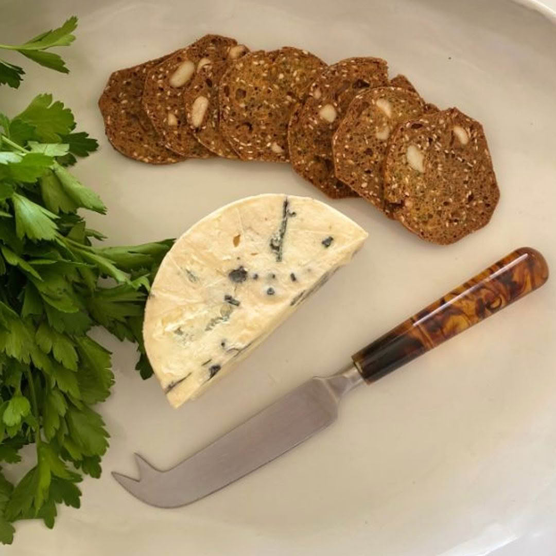 Blue cheese with crackers and parsley on plate