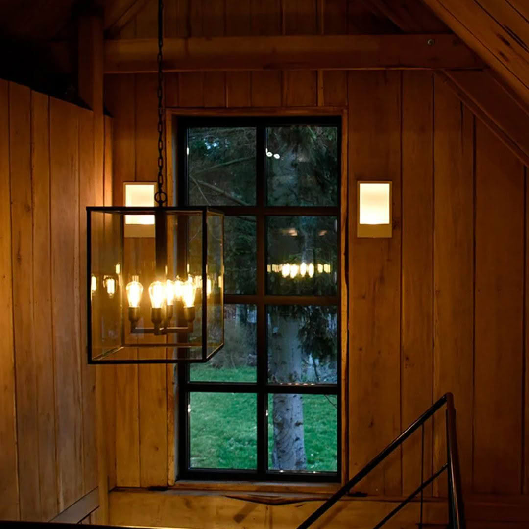 Chandelier inside cozy wooden cabin with forest view